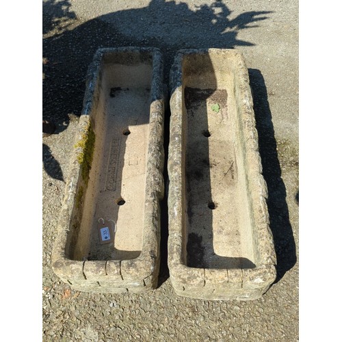 33 - A pair of concrete trough planters of rectangular form with simulated rusticated blockwork sides, ea... 