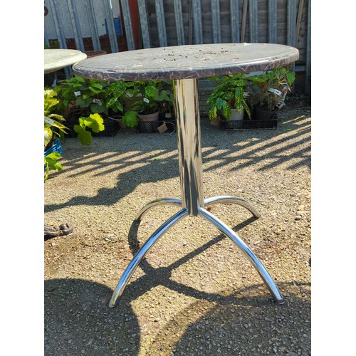 40 - Contemporary bistro table with circular grey marble-effect top, the rimmed edge above a polished chr... 