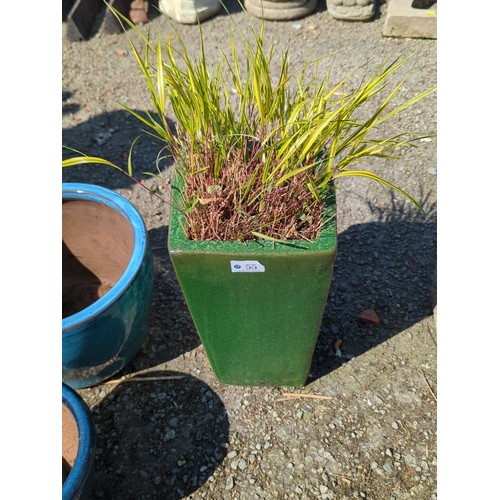 55 - Glazed ceramic planter of square tapering form, finished in mottled green glaze with thickened rim; ... 