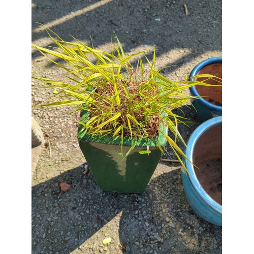 55 - Glazed ceramic planter of square tapering form, finished in mottled green glaze with thickened rim; ... 