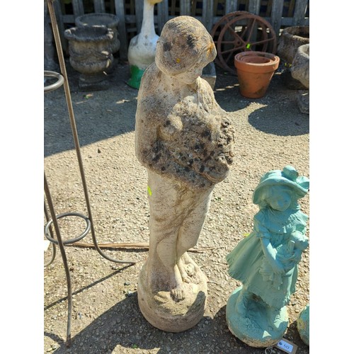 59 - Concrete figure of a young girl cradling a basket of fruit raised on an integral circular plinth wit... 