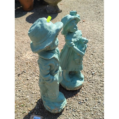 60 - A pair of painted concrete garden figures modelled as children in period dress—one a boy in brimmed ... 