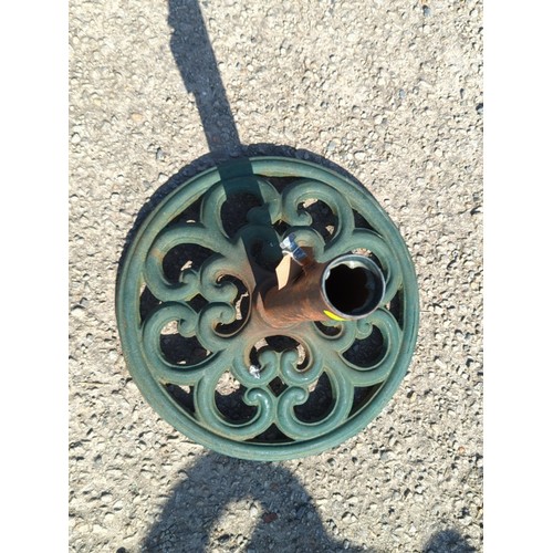 62 - Cast-iron parasol stand with circular pierced scrolling base and central tubular pole receptacle; gr... 