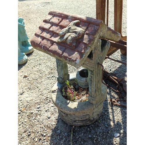 63 - Concrete wishing well garden ornament—modelled as a brick-lined well with simulated timber uprights,... 