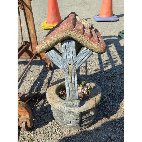 63 - Concrete wishing well garden ornament—modelled as a brick-lined well with simulated timber uprights,... 