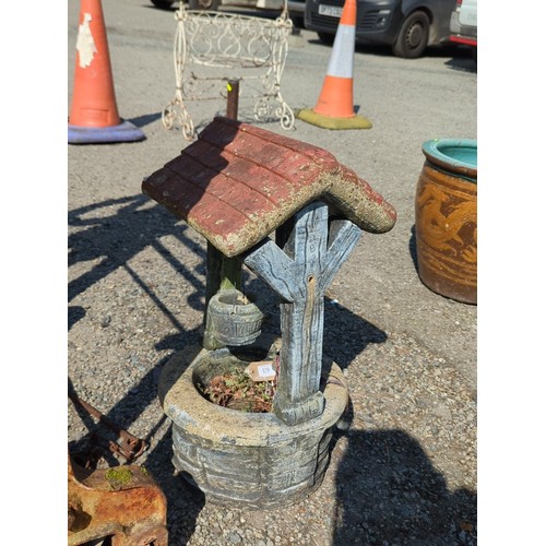 63 - Concrete wishing well garden ornament—modelled as a brick-lined well with simulated timber uprights,... 