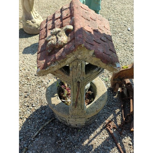 63 - Concrete wishing well garden ornament—modelled as a brick-lined well with simulated timber uprights,... 