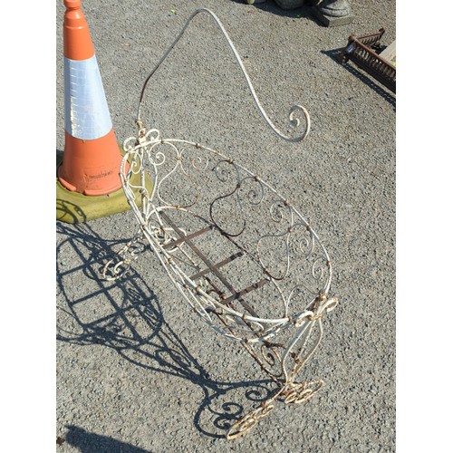 64 - Painted metal crib, the oval basket with scrolling wirework and ball finials above a stretchered bas... 