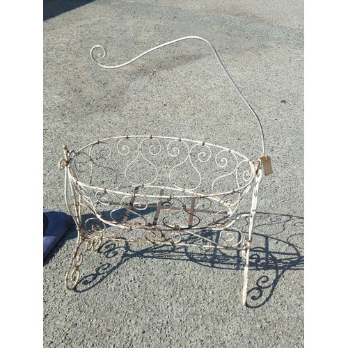64 - Painted metal crib, the oval basket with scrolling wirework and ball finials above a stretchered bas... 