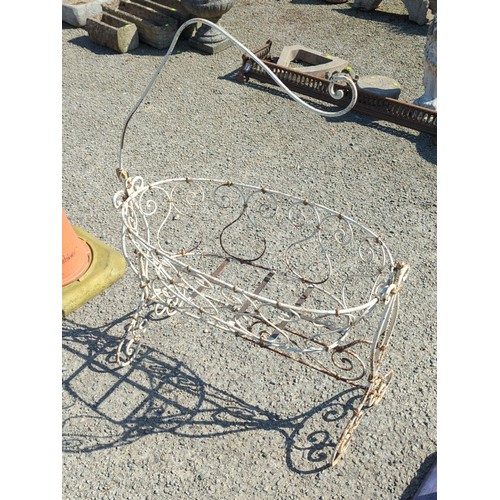 64 - Painted metal crib, the oval basket with scrolling wirework and ball finials above a stretchered bas... 