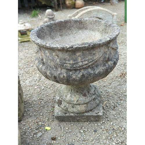70 - Concrete garden urn of campana form, the exterior moulded with swags and stiff-leaf ornament, raised... 