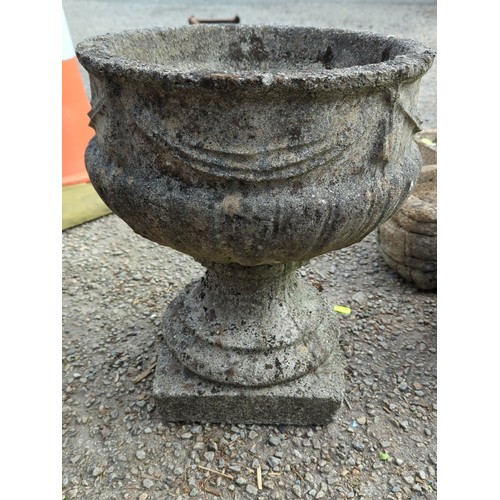 70 - Concrete garden urn of campana form, the exterior moulded with swags and stiff-leaf ornament, raised... 