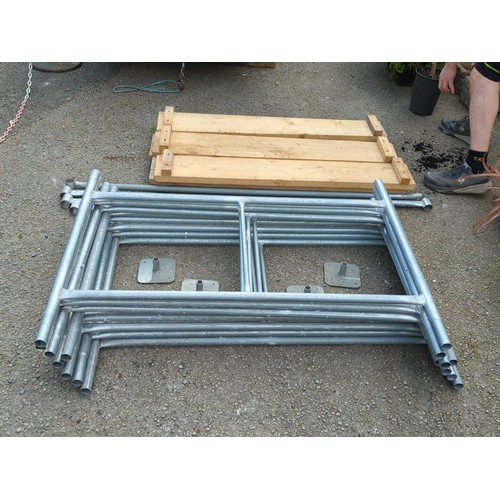 74 - A group of galvanised steel scaffold frames and tubular bracing, with square base plates, accompanie... 