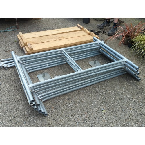 74 - A group of galvanised steel scaffold frames and tubular bracing, with square base plates, accompanie... 