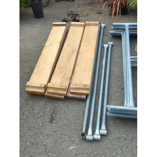 74 - A group of galvanised steel scaffold frames and tubular bracing, with square base plates, accompanie... 