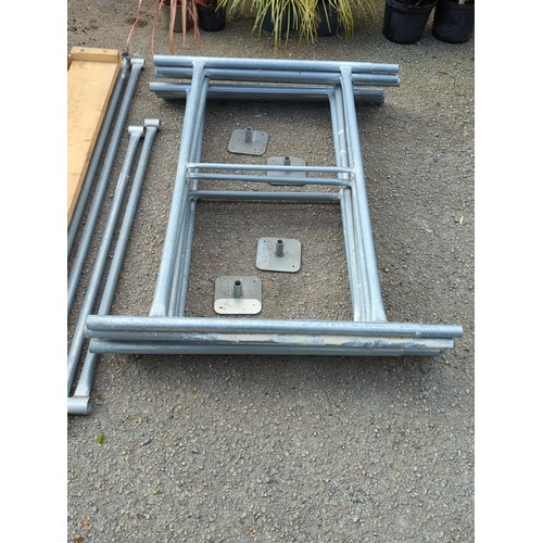 74 - A group of galvanised steel scaffold frames and tubular bracing, with square base plates, accompanie... 
