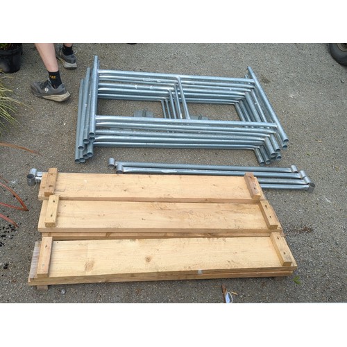 74 - A group of galvanised steel scaffold frames and tubular bracing, with square base plates, accompanie... 
