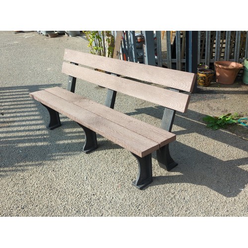 76 - Contemporary outdoor bench with moulded faux-wood slats forming a two-plank seat and twin back rails... 