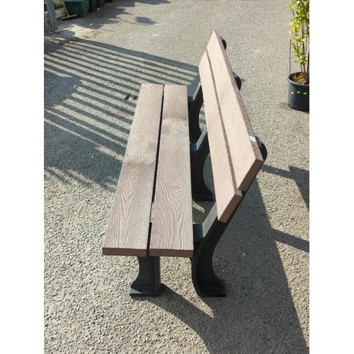 76 - Contemporary outdoor bench with moulded faux-wood slats forming a two-plank seat and twin back rails... 