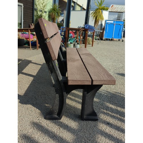 76 - Contemporary outdoor bench with moulded faux-wood slats forming a two-plank seat and twin back rails... 