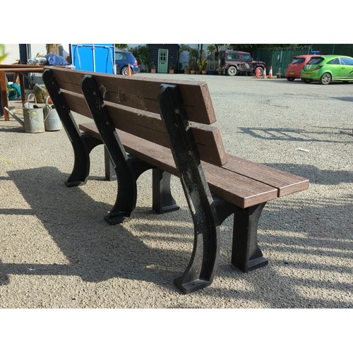76 - Contemporary outdoor bench with moulded faux-wood slats forming a two-plank seat and twin back rails... 