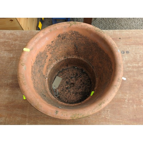 78 - Large terracotta garden flowerpot of tapering cylindrical form with broad rolled rim and drainage ho... 