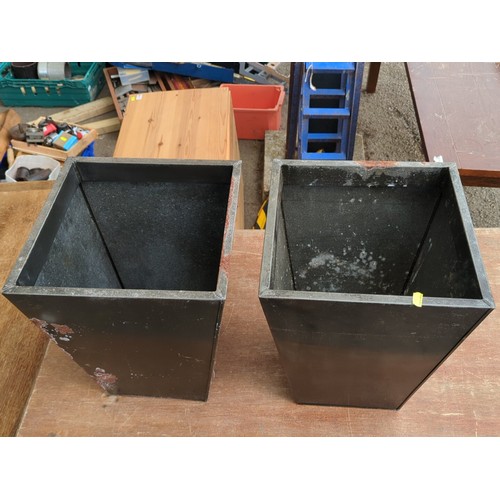 80 - A pair of black metal tapering square-plan planters, each of open top form with rolled rim and reces... 