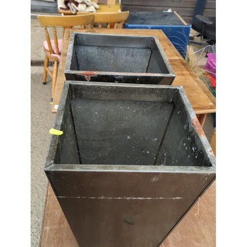 80 - A pair of black metal tapering square-plan planters, each of open top form with rolled rim and reces... 