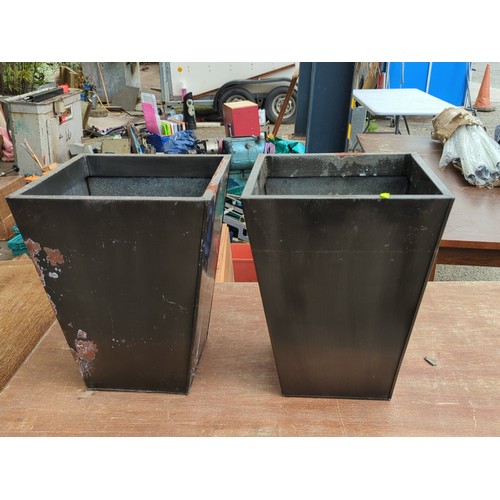 80 - A pair of black metal tapering square-plan planters, each of open top form with rolled rim and reces... 