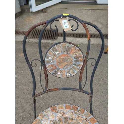81 - Metal garden chair with scrolling back splat, centred by a circular mosaic roundel; matching circula... 