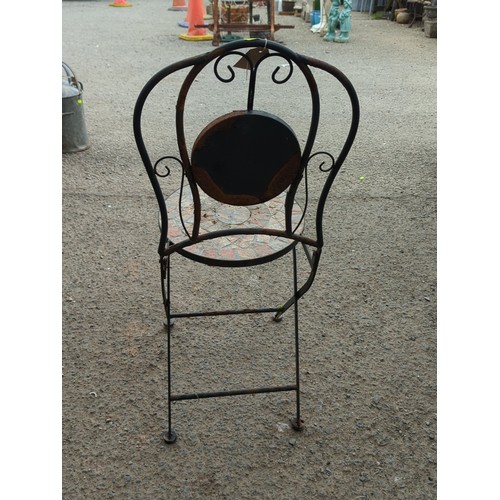 81 - Metal garden chair with scrolling back splat, centred by a circular mosaic roundel; matching circula... 