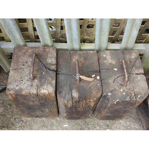 82 - A group of 3 timber blocks fitted with an iron staple handle to the top.