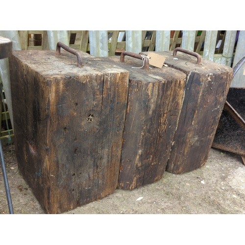 82 - A group of 3 timber blocks fitted with an iron staple handle to the top.