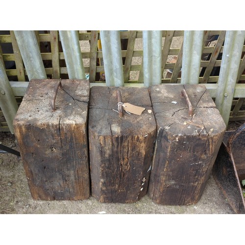 82 - A group of 3 timber blocks fitted with an iron staple handle to the top.
