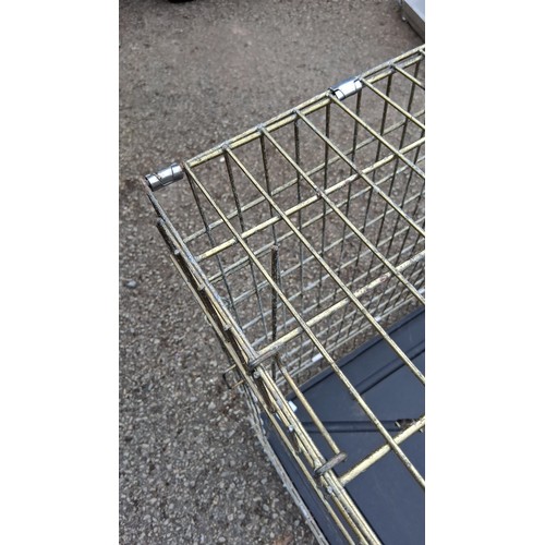 101 - A rectangular wire pet crate in metal with hinged door, carrying handles, and removable black plasti... 