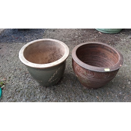 88 - A pair of ceramic garden planters, one green-glazed, the other terracotta; drainage holes to bases.