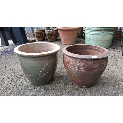 88 - A pair of ceramic garden planters, one green-glazed, the other terracotta; drainage holes to bases.