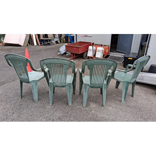 98 - A group of 4 plastic garden armchairs, in green, with slatted backs and curved arms.