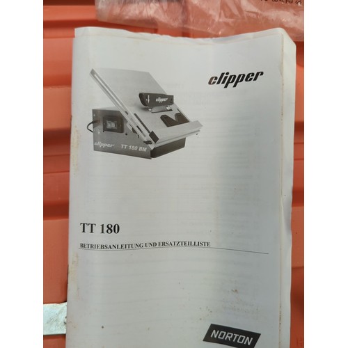 134 - Norton Clipper TT 180 electric tile saw with operating manual, housed in the original orange moulded... 
