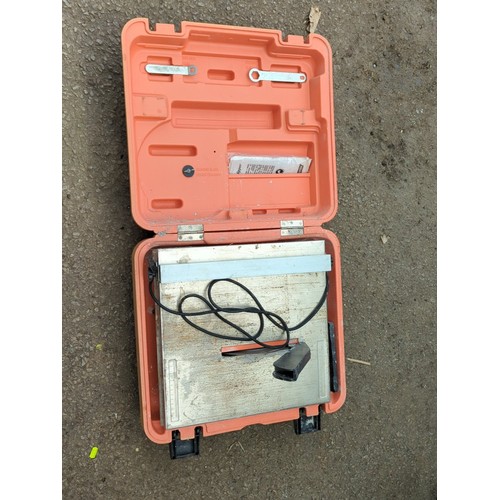 134 - Norton Clipper TT 180 electric tile saw with operating manual, housed in the original orange moulded... 