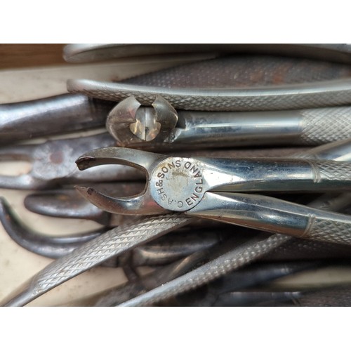 151 - A quantity of vintage dental extraction forceps and related instruments, various patterns with knurl... 