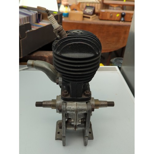 155 - Small air-cooled single-cylinder engine with finned cylinder head, side exhaust outlet, and twin-end... 