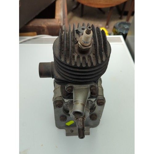 155 - Small air-cooled single-cylinder engine with finned cylinder head, side exhaust outlet, and twin-end... 