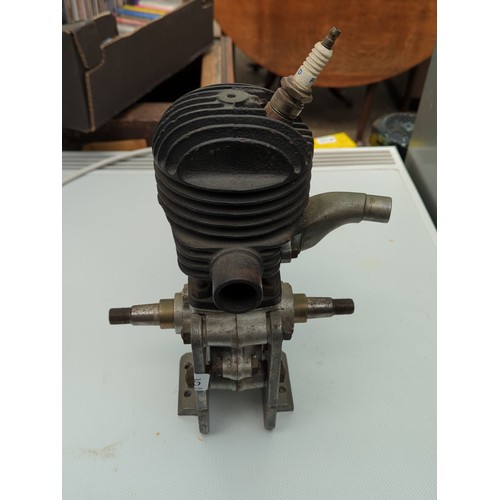 155 - Small air-cooled single-cylinder engine with finned cylinder head, side exhaust outlet, and twin-end... 