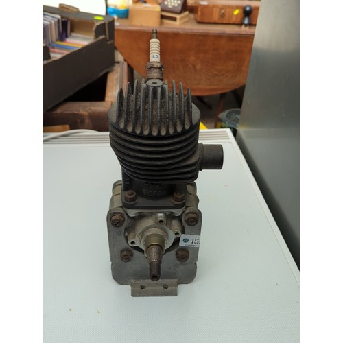 155 - Small air-cooled single-cylinder engine with finned cylinder head, side exhaust outlet, and twin-end... 