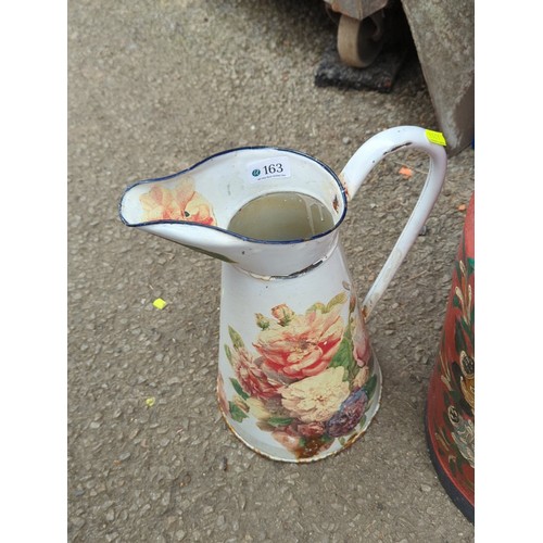163 - Hand-painted floral milk churn with hinged lid and swing handle, together with an enamelled ewer.