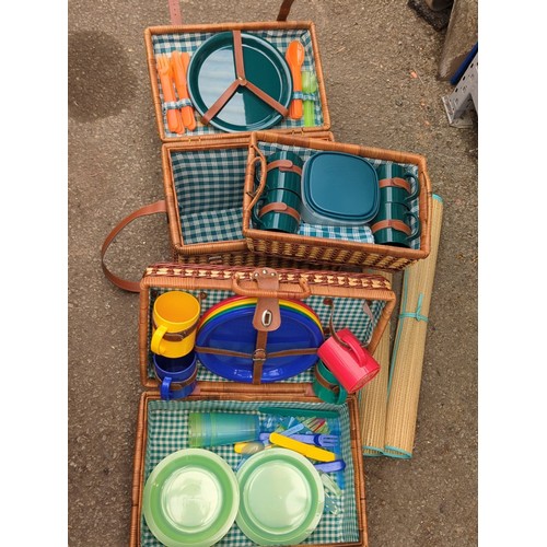 164 - Two wicker picnic hampers fitted with plastic picnic ware; together with a pair of rolled woven beac... 