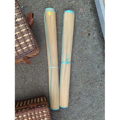 164 - Two wicker picnic hampers fitted with plastic picnic ware; together with a pair of rolled woven beac... 