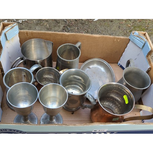 177 - A group of metal tavern and kitchen wares, including pewter goblets and mugs, a lidded tankard, grad... 