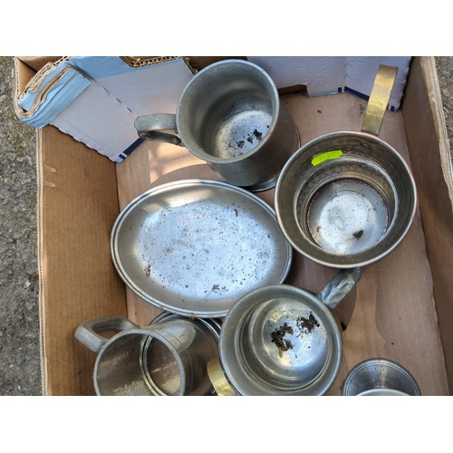 177 - A group of metal tavern and kitchen wares, including pewter goblets and mugs, a lidded tankard, grad... 